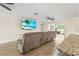 Bright living room showcasing a large sofa, neutral walls, and a sliding glass door at 7391 W Country Club N Dr, Sarasota, FL 34243