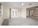 Spacious living room with neutral carpet, ceiling fan and sliding glass door access to another room at 7391 W Country Club N Dr, Sarasota, FL 34243