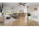 Open-concept living area featuring tile floors, ceiling fans, and seamless access to the kitchen and dining spaces at 7391 W Country Club N Dr, Sarasota, FL 34243