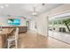 Bright open living space leading to a screened-in lanai with water views at 7391 W Country Club N Dr, Sarasota, FL 34243