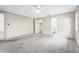 Large primary bedroom features neutral carpeting, ceiling fan, and en-suite bathroom at 7391 W Country Club N Dr, Sarasota, FL 34243