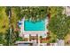 Community swimming pool offers a refreshing escape surrounded by lush landscaping and ample lounge seating at 7391 W Country Club N Dr, Sarasota, FL 34243