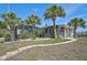 The backyard features beautiful landscaping and a screened-in pool area for outdoor entertaining at 801 E 5Th St, Englewood, FL 34223