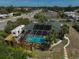 Aerial view of backyard featuring screened pool, patio, RV parking, and tropical landscaping at 801 E 5Th St, Englewood, FL 34223