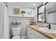Charming bathroom with white subway tile, wood countertop, updated fixtures, and crab decor at 801 E 5Th St, Englewood, FL 34223