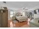 Spacious primary bedroom with wood floors, neutral colors, ceiling fan, and sliding glass door to screened porch at 801 E 5Th St, Englewood, FL 34223