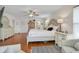A light and airy bedroom featuring hardwood floors, white furniture, and slider doors to another room at 801 E 5Th St, Englewood, FL 34223