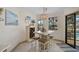 Cozy dining area with seating for four, modern lighting, and view of the backyard pool at 801 E 5Th St, Englewood, FL 34223