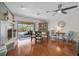 Hardwood floors define the dining area with a view to the pool and adjacent to a fireplace at 801 E 5Th St, Englewood, FL 34223