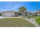 Charming single-story home with a well-manicured lawn and inviting front entrance, featuring a two-car garage at 801 E 5Th St, Englewood, FL 34223