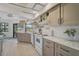 Bright kitchen with stainless steel appliances, white marble countertops, and neutral-toned cabinetry at 801 E 5Th St, Englewood, FL 34223