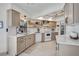 Bright kitchen with neutral-toned cabinets, white marble countertops, and stainless steel appliances at 801 E 5Th St, Englewood, FL 34223