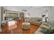 A seamless blend of living and dining spaces with hardwood floors, stylish furniture, and a view of the pool at 801 E 5Th St, Englewood, FL 34223