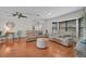 A well-lit living room with hardwood floors, comfortable seating, and views to the front and rear at 801 E 5Th St, Englewood, FL 34223