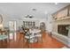 Bright living room features a dining area, fireplace, and an open floor plan with wood flooring throughout at 801 E 5Th St, Englewood, FL 34223