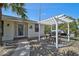 Charming patio area with pergola, dining set, and brick pavers providing an inviting outdoor space at 801 E 5Th St, Englewood, FL 34223