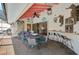 Entertain on this covered patio with a wet bar, outdoor dining, and cozy seating area at 801 E 5Th St, Englewood, FL 34223