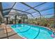 A clean and inviting pool area is screened in to keep debris out and provides easy access to the backyard at 801 E 5Th St, Englewood, FL 34223