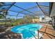 Enjoy a refreshing dip in this private screened-in pool surrounded by lush landscaping and a patio at 801 E 5Th St, Englewood, FL 34223