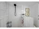 Stylish shower with white tile, a sleek shower head, and built in shelving at 801 E 5Th St, Englewood, FL 34223