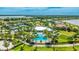 Aerial view of the community pool, tennis courts, townhomes and lake at 801 Seascape Pl, Sarasota, FL 34240