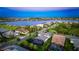 Sunset aerial view of the home and community near a scenic lake at 801 Seascape Pl, Sarasota, FL 34240