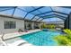 Aerial view of a private pool with lounge chairs and lush landscaping at 801 Seascape Pl, Sarasota, FL 34240