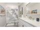 Bright bathroom featuring a stylish cloud shower curtain, and a quartz countertop at 801 Seascape Pl, Sarasota, FL 34240