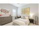 Bright bedroom with neutral colors, comfortable bed, and decorative art for a relaxing space at 801 Seascape Pl, Sarasota, FL 34240