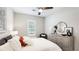 Bedroom featuring neutral walls, comfortable bed, and a dresser adorned with elegant decor at 801 Seascape Pl, Sarasota, FL 34240