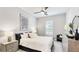 Bedroom with soft lighting, plush bedding, decorative artwork, and a ceiling fan at 801 Seascape Pl, Sarasota, FL 34240
