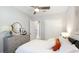 Bedroom showcasing closet doors, a comfortable bed, and tastefully decorated dresser at 801 Seascape Pl, Sarasota, FL 34240