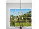 Unique chandelier featured in a home with a large window overlooking manicured landscaping at 801 Seascape Pl, Sarasota, FL 34240