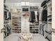 Walk-in closet with custom shelving, drawers, and ample storage for shoes and clothing at 801 Seascape Pl, Sarasota, FL 34240