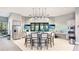 Modern community kitchen with island seating, stainless steel appliances, and stylish lighting at 801 Seascape Pl, Sarasota, FL 34240