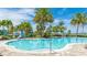 Community pool featuring a large deck area for poolside lounging and lakeside views at 801 Seascape Pl, Sarasota, FL 34240