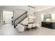 Elegant dining room featuring modern chandelier and a staircase at 801 Seascape Pl, Sarasota, FL 34240