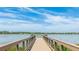 Community fishing pier on a lake with expansive views of blue skies and surrounding homes at 801 Seascape Pl, Sarasota, FL 34240