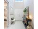 Bright foyer with high ceilings, elegant decor, and a view of the bedroom at 801 Seascape Pl, Sarasota, FL 34240