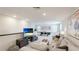 Spacious game room with ping pong, comfortable sofa, tv, and playful decor at 801 Seascape Pl, Sarasota, FL 34240