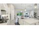 Modern kitchen with an island, seamlessly connected to the living room and outdoor patio at 801 Seascape Pl, Sarasota, FL 34240