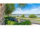 Beautiful lake view with benches surrounded by lush landscaping and trees at 801 Seascape Pl, Sarasota, FL 34240