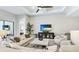 Bright living room featuring modern décor, a ceiling fan, and a comfortable seating area at 801 Seascape Pl, Sarasota, FL 34240