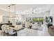 Bright, open-concept living room with sleek tile flooring and large windows overlooking the pool at 801 Seascape Pl, Sarasota, FL 34240