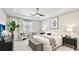 Serene main bedroom with tray ceilings, a ceiling fan, and a cozy seating area at 801 Seascape Pl, Sarasota, FL 34240