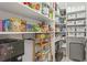 Well-organized pantry with ample shelving, storage baskets, and a beverage station at 801 Seascape Pl, Sarasota, FL 34240