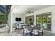 Outdoor patio with a dining table, seating, and a view of the pool and lush landscaping at 801 Seascape Pl, Sarasota, FL 34240