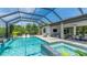 Stunning screened-in pool and spa area with an outdoor seating and dining area, perfect for relaxation at 801 Seascape Pl, Sarasota, FL 34240