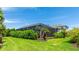 Backyard featuring a large screened in lanai with lush landscaping at 801 Seascape Pl, Sarasota, FL 34240