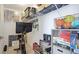Organized storage room with shelving, a TV, games, books, and decorative items at 801 Seascape Pl, Sarasota, FL 34240